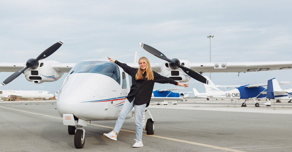 A participant beside a light aircraft